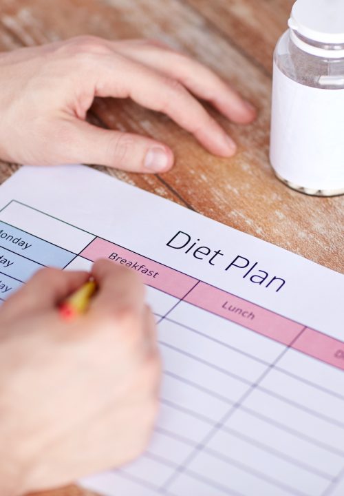 Filling in a diet plan on paper